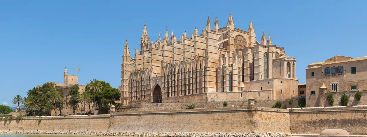Palma Cathedral (La Seu) seen across the reflecting pool of Parc de la Mar, with the Almudaina Palace beside it