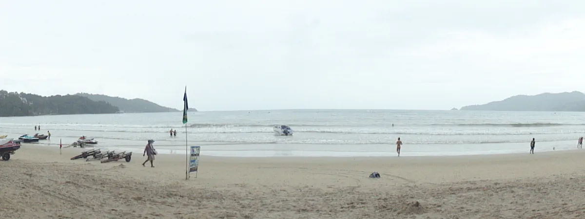 Panoramic view of Patong Beach's crescent bay, lined with hotels and hills in Phuket