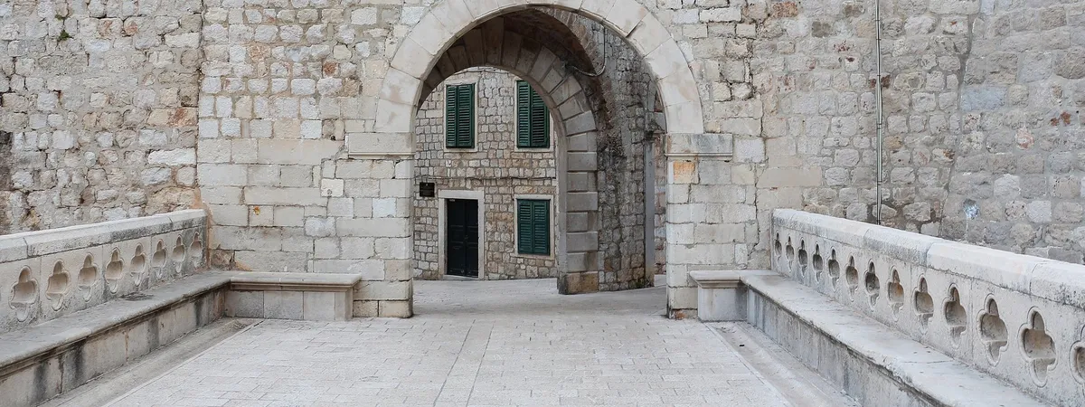 The stone archway of Ploče Gate, one of the historic entrances to Dubrovnik's Old Town, leading toward the Ploče district