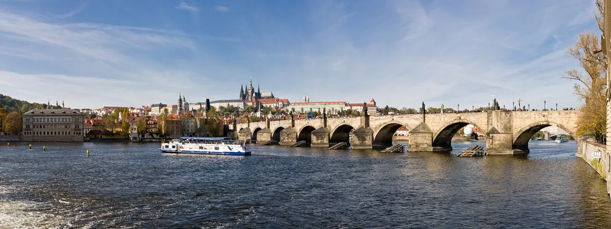 A panoramic view across the Vltava river to Prague Castle and Charles Bridge