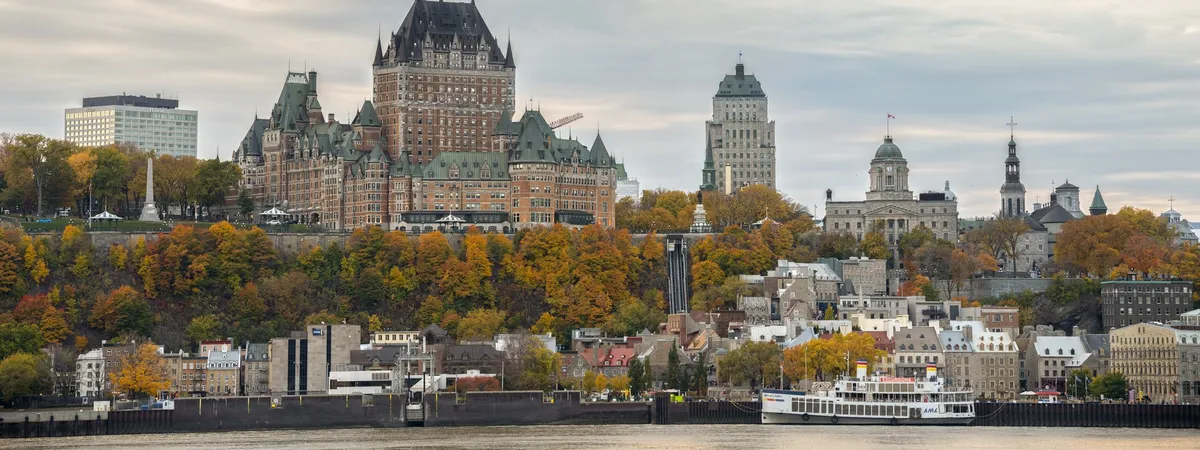Château Frontenac and Old Quebec's rooftops seen across the St. Lawrence River in autumn