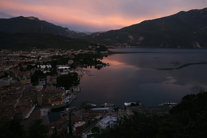 Riva del Garda and its harbour at dusk, at the head of Lake Garda between steep cliffs