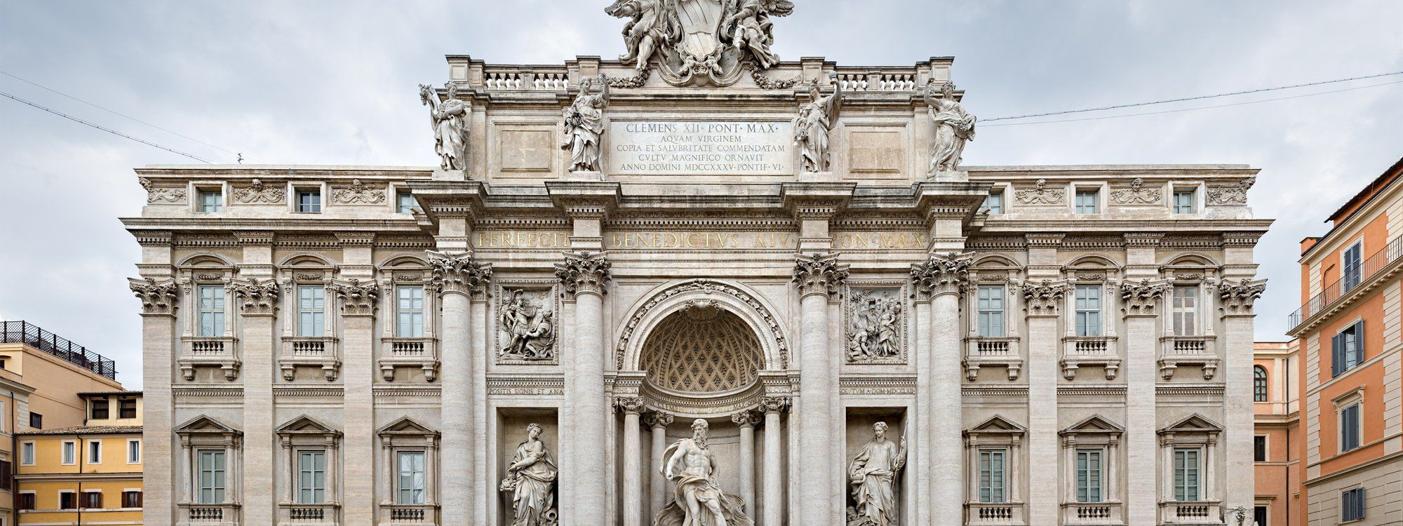 The Trevi Fountain in Rome, with its Baroque facade of statues and columns rising behind the water