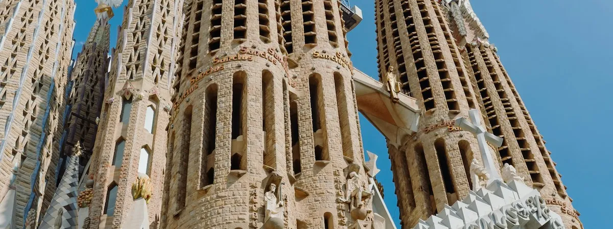 Sagrada Família's ornate spires rising against a clear blue sky