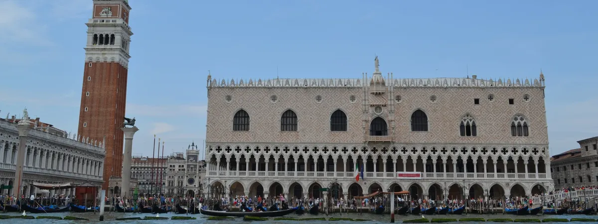 The Doge's Palace and the brick Campanile bell tower rising above Piazza San Marco in Venice, seen from the lagoon