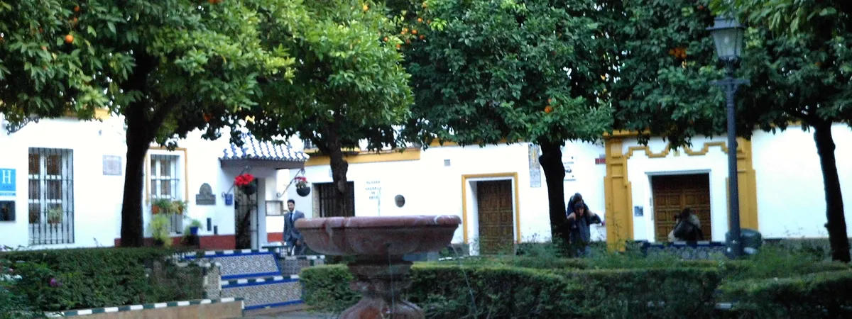 The tiled fountain and orange trees of Plaza de Doña Elvira in Seville's Santa Cruz quarter