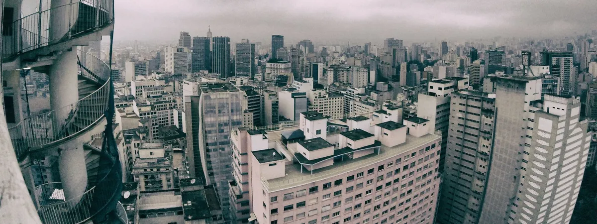 Aerial view over São Paulo's dense downtown skyline from the curved balconies of Edifício Copan
