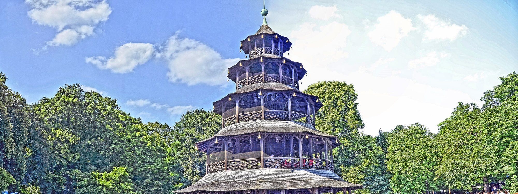 The wooden, pagoda-style Chinese Tower rising above the trees in Munich's Englischer Garten, on Schwabing's edge