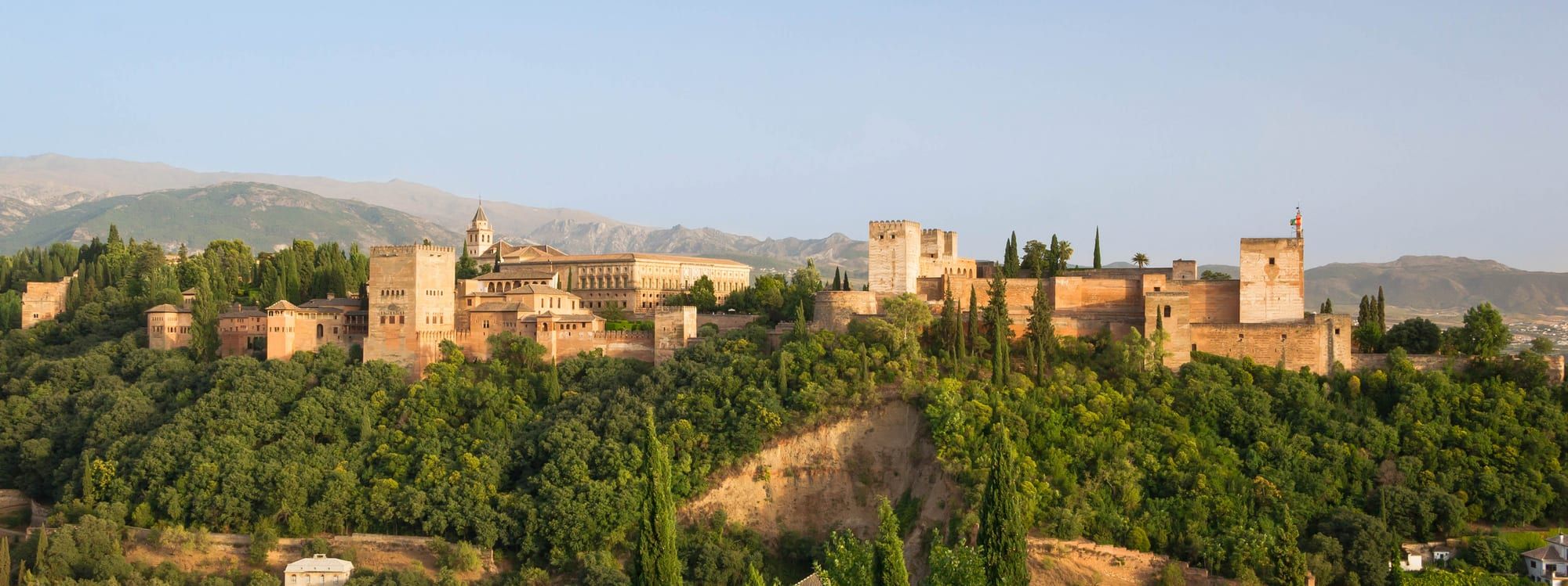 The Alhambra palace and fortress in Granada, seen from across the valley at golden hour
