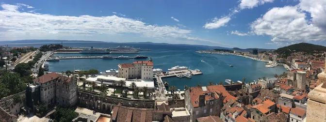 Aerial view over Split's old town rooftops and harbor from the cathedral bell tower