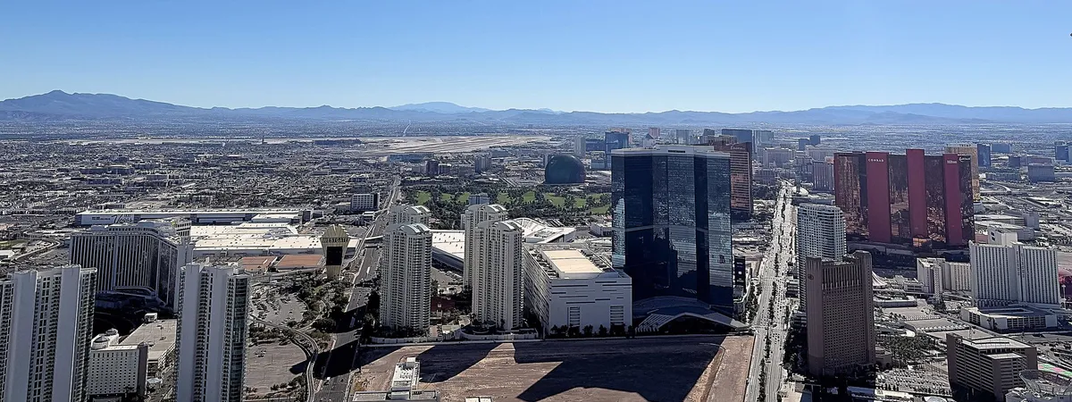 Aerial view of the Las Vegas Strip from the STRAT observation deck, looking south past the Wynn, Encore, and Conrad/Hilton towers toward the rest of the boulevard