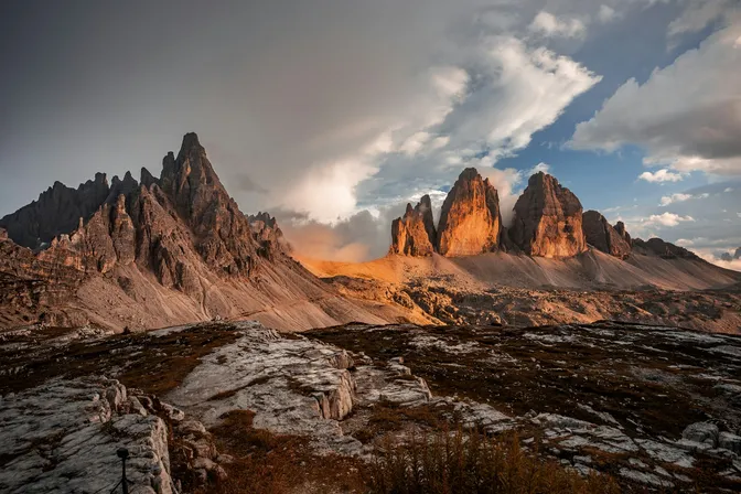 The north faces of the Tre Cime di Lavaredo catching late light, with the Paternkofel ridge to the left