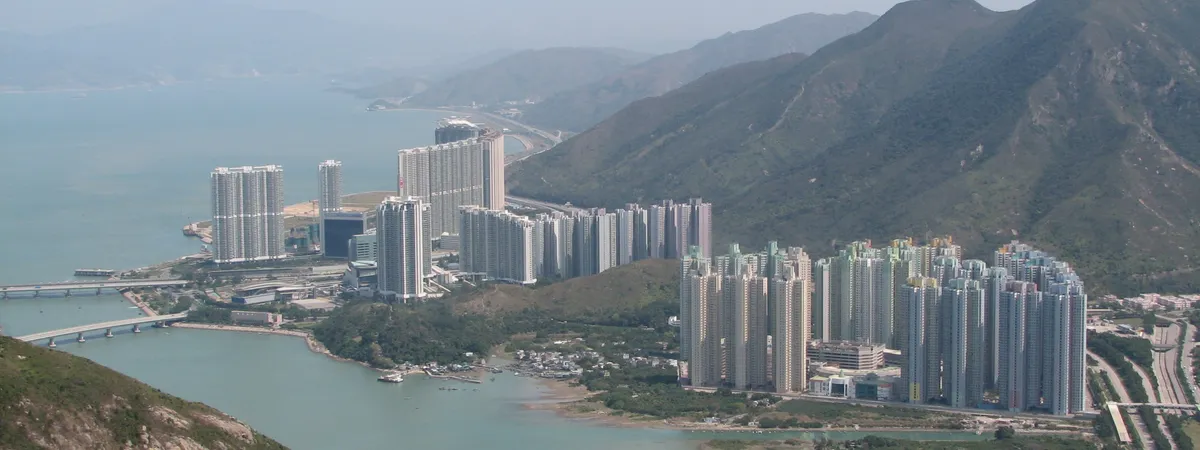 Aerial view of Tung Chung new town between the mountains and the sea on Lantau Island, seen from the Ngong Ping cable car