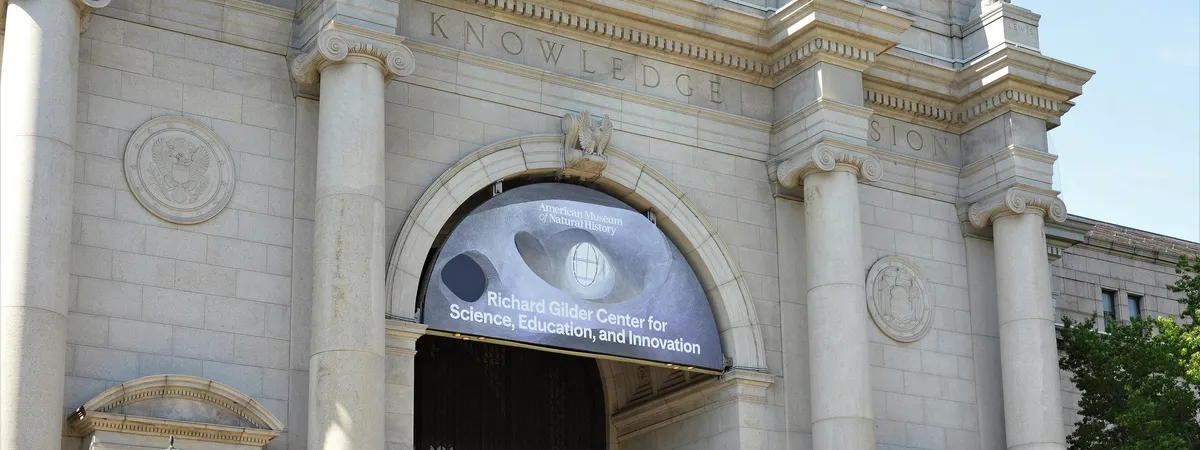 The Central Park West entrance of the American Museum of Natural History, with its stone columns and carved 'Knowledge' inscription