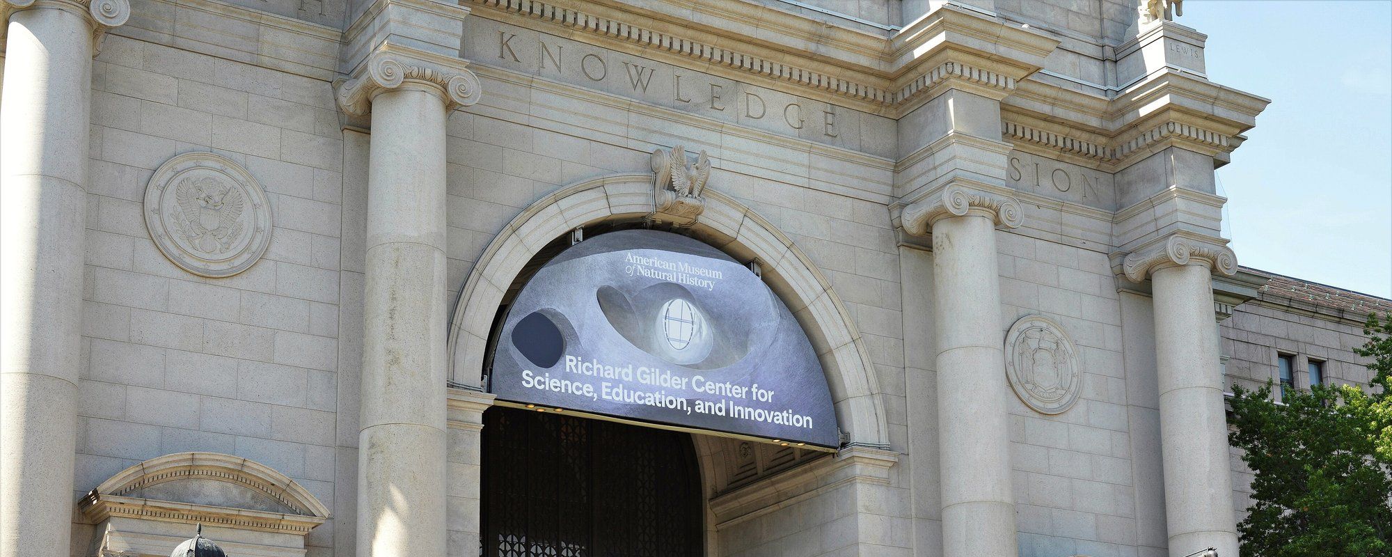 The Central Park West entrance of the American Museum of Natural History, with its stone columns and carved 'Knowledge' inscription