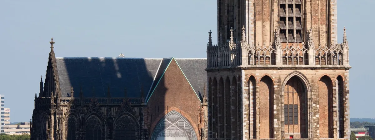The Gothic Dom Tower rising beside the Buurkerk church in Utrecht's historic center