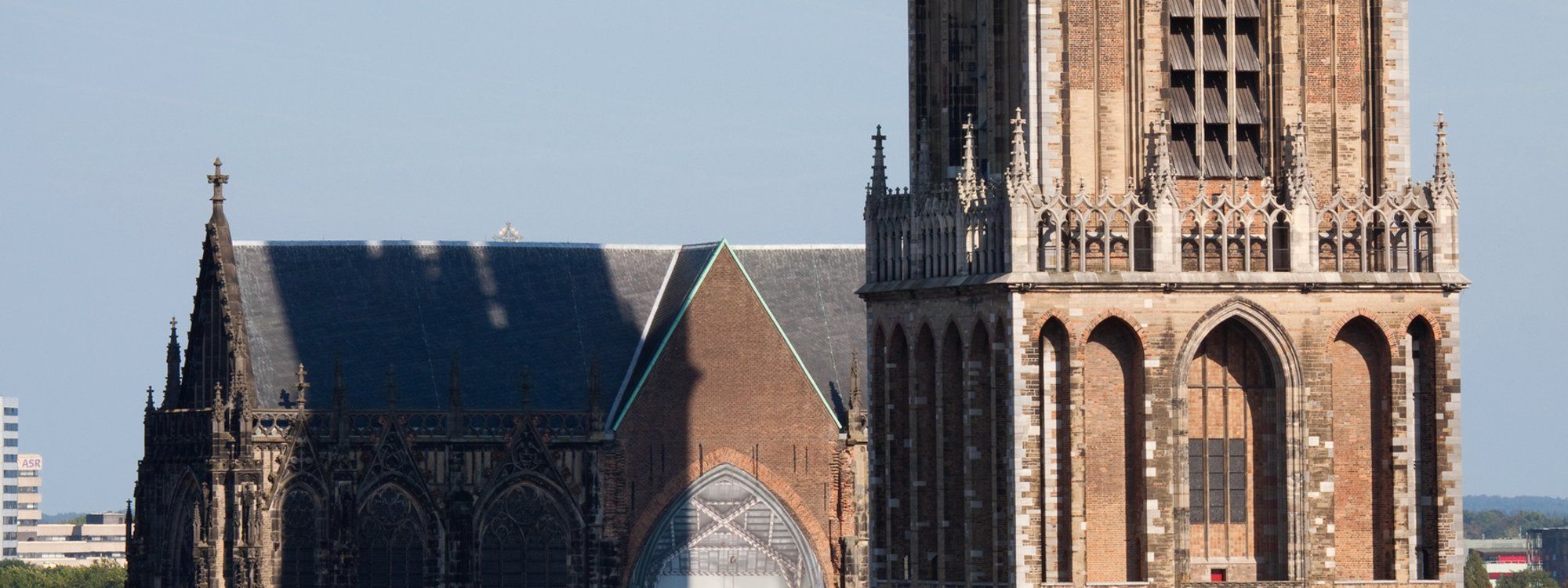 The Gothic Dom Tower rising beside the Buurkerk church in Utrecht's historic center