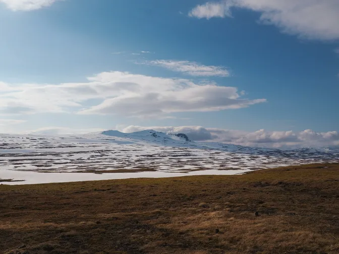 Snow-streaked highland slopes above the open countryside near Varmahlíð