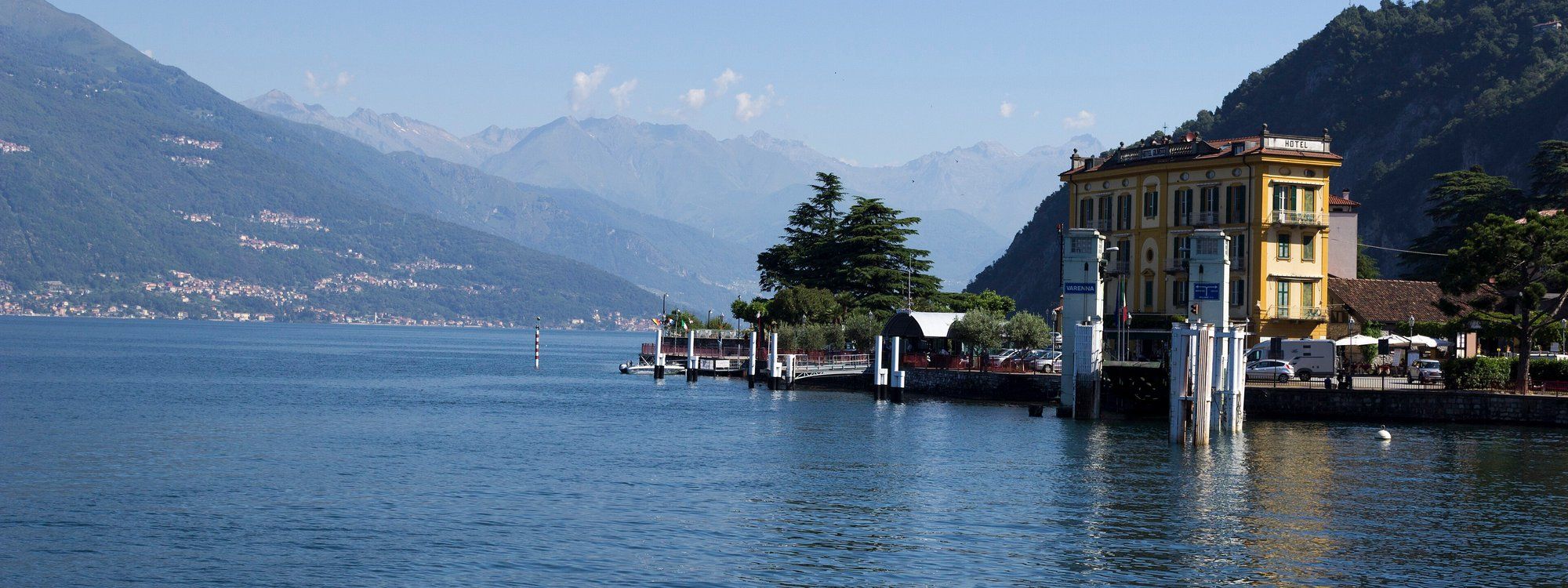 Varenna’s ferry pier and the yellow Hotel Olivedo on the quayside, with Lake Como opening out beyond