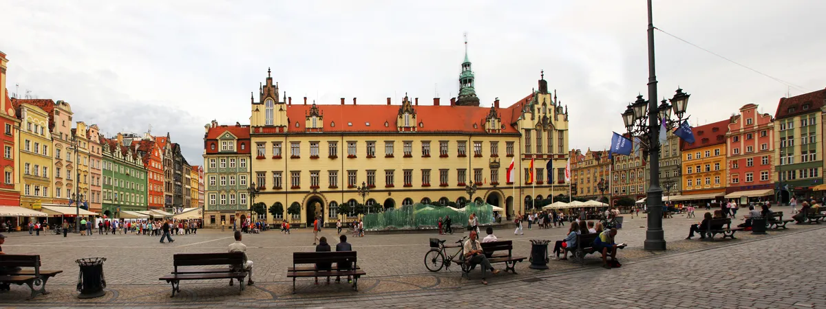 Wrocław's Market Square (Rynek) with the Gothic-Renaissance Old Town Hall at its center, framed by colorful merchant houses