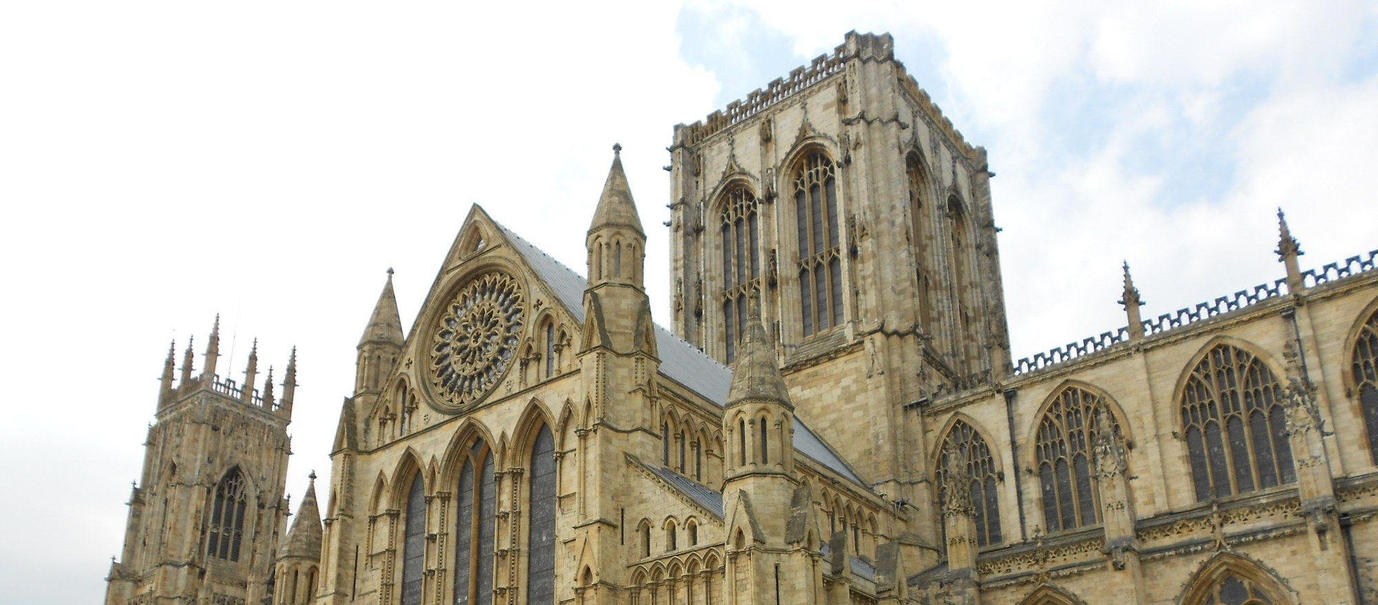 The south transept and towers of York Minster, seen from Deangate on a bright day